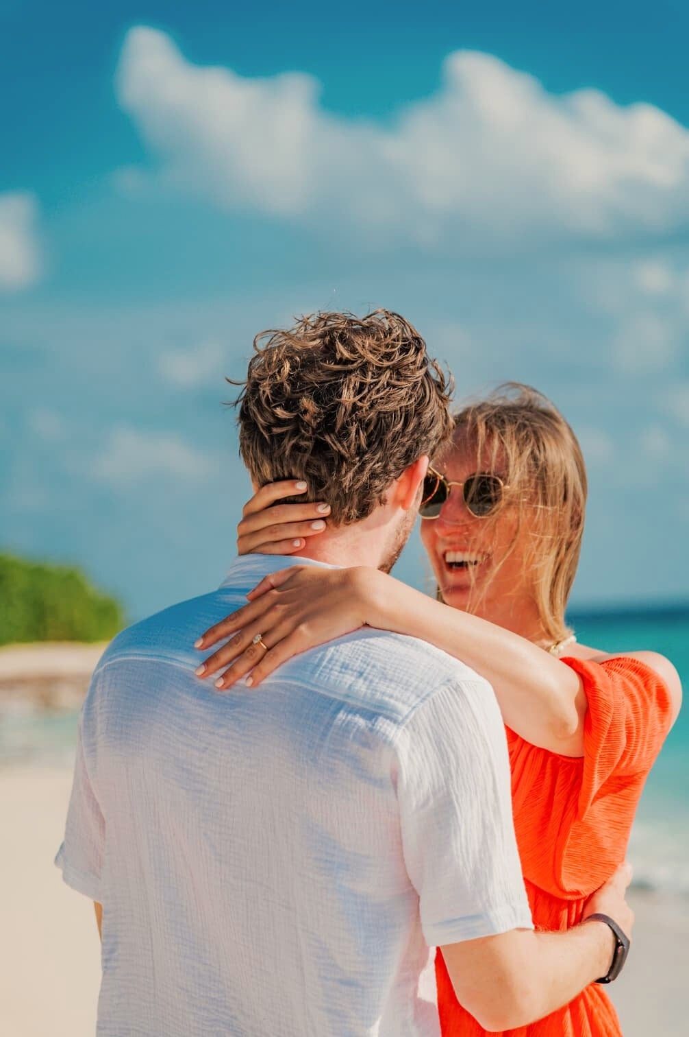 Leonard and Mona embracing on the beach