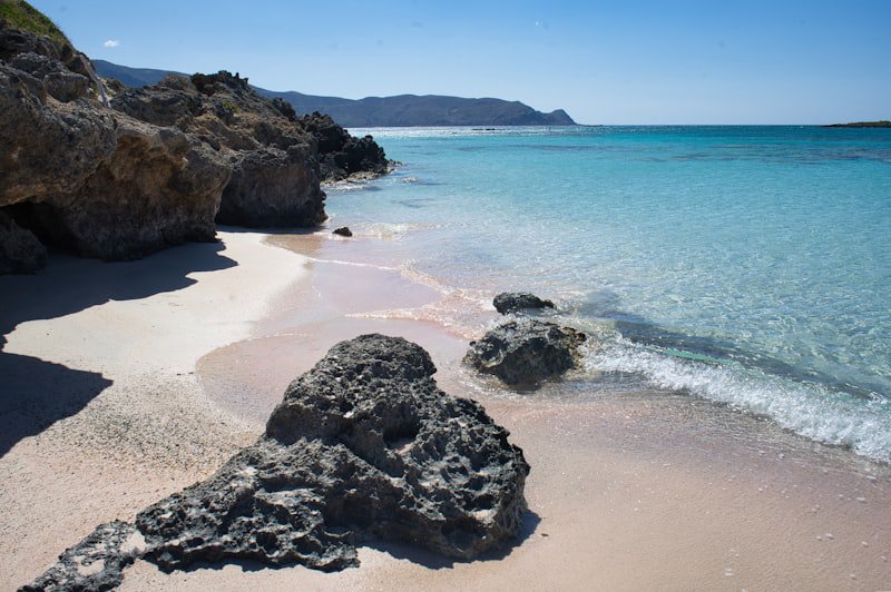 Pink-tinged sand and shallow turquoise water at Elafonisi Beach