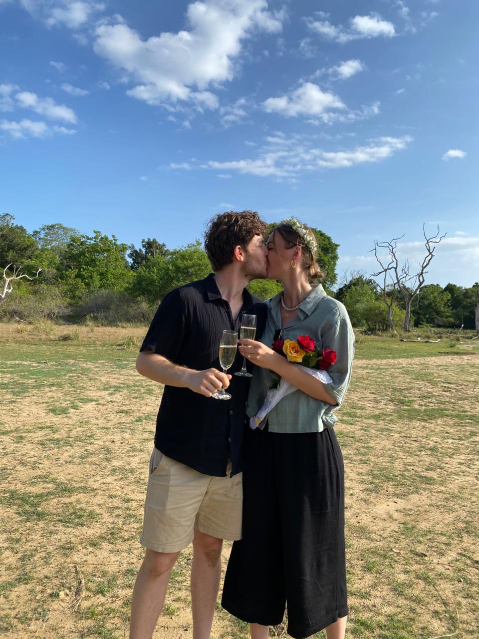 Leonard and Mona kissing and toasting with champagne after the proposal