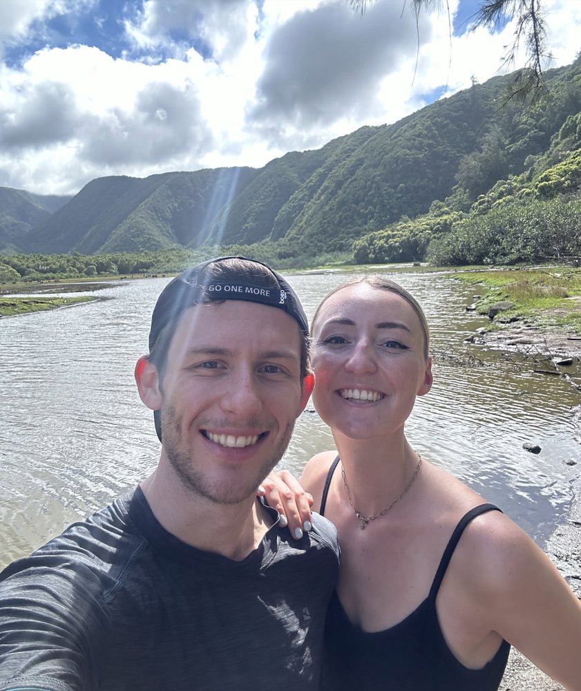 Leonard and Mona by a river in a lush Hawaiian valley