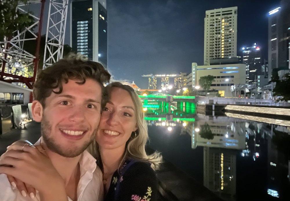 Leonard and Mona in front of the Singapore skyline at night